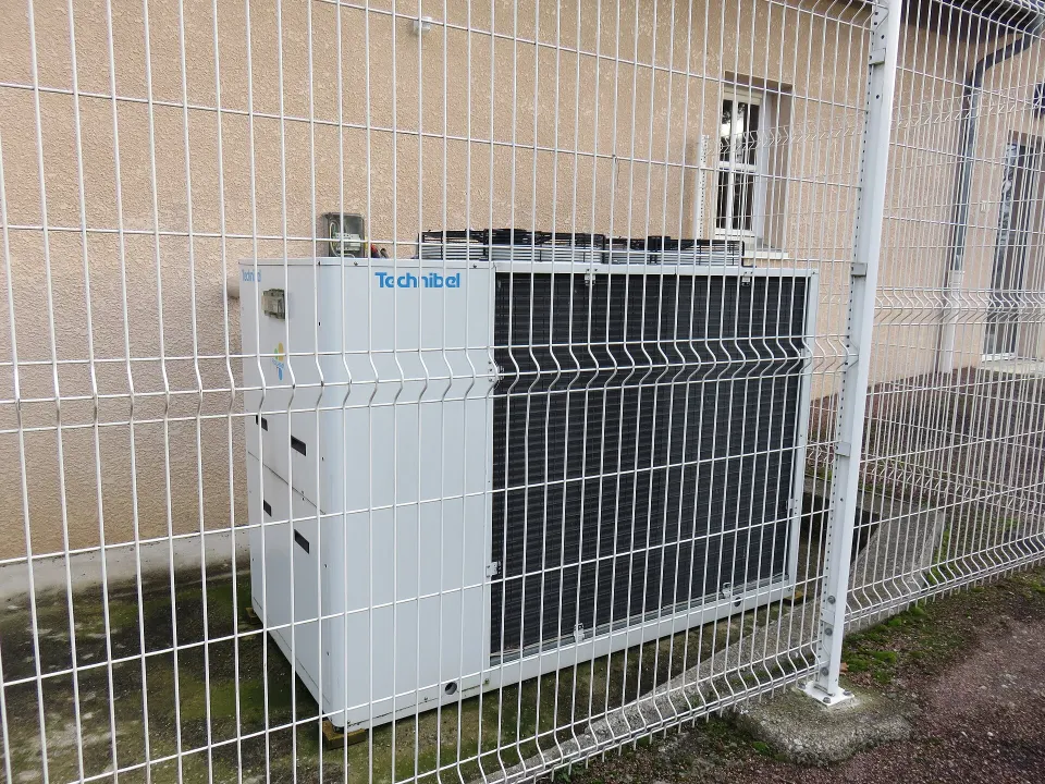 Unité extérieure d'une pompe à chaleur contre la façade d'un bâtiment, à Saint-Vincent-de-Boisset, dans la Loire